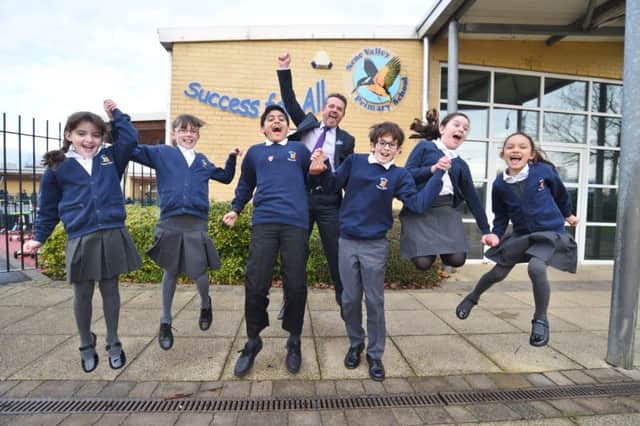 Sophie Reid, Katie Yule, Talaal Zubair, James Law, Emily Hurst and Alisha Robinson celebrating their  OFSTED result at Nene Valley primary school with head teacher  Stuart Mansell EMN-170117-180813009