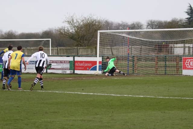 Peterborough Northern Star goalkeeper Dan George saves a penalty at Wellingborough. Photo: Tim Gates.