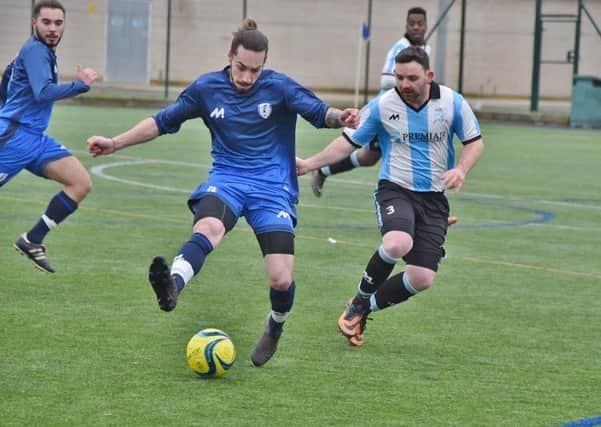 Action from Peterborough League Division Four as Premiair (stripes) beat Feeder FC 3-1. Photo: David Lowndes.