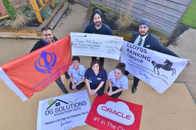 Thorpe Hall hospice nurses Carole Spridgeon, Fern Dettmer and Kate Rennie with fundraiser Nelish Patel receive cheque from Del Singh, who climbed Kilimangaro, and his brother Kav Singh. EMN-170123-161842009