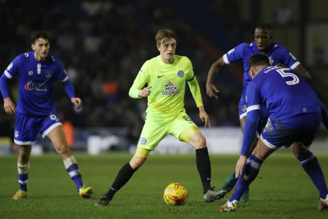 Posh skipper Chris Forrester is surrounded by Oldham players. Photo: Joe Dent/theposh.com.