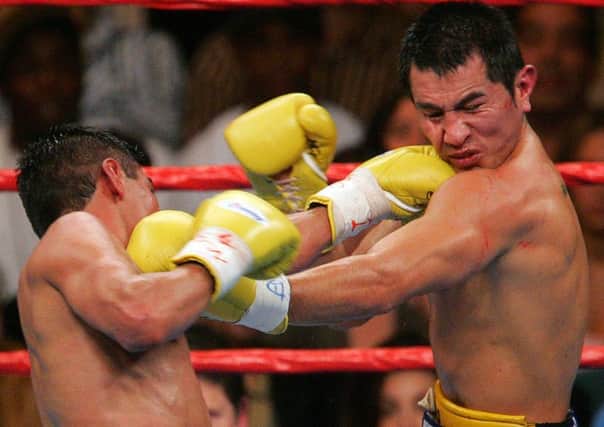 Erik Morales (left) and Marco Antonio Barrera exchange blows in one of their classic world title fights.