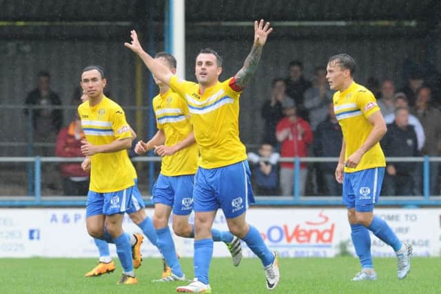 On-loan Spalding striker Leon Mettam celebrates a goal for King's Lynn.