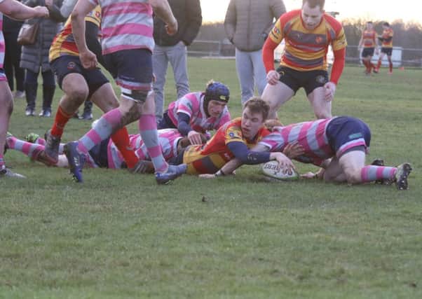 Tom Williams scores one of his three tries against Olney. Picture: Mick Sutterby