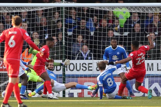 Posh survived this goalmouth scramble during the heavy defeat by MK Dons. Photo: Joe Dent/theposh.com.
