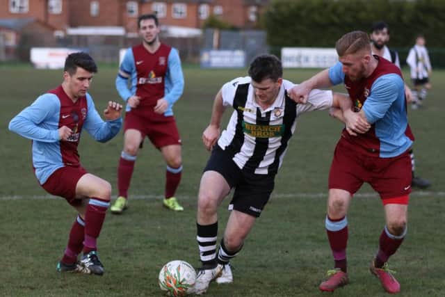 Peterborough Northern Star goalscorer James Hill-Seekings (stripes) in action against Deeping Rangers. Photo: Tim Gates.