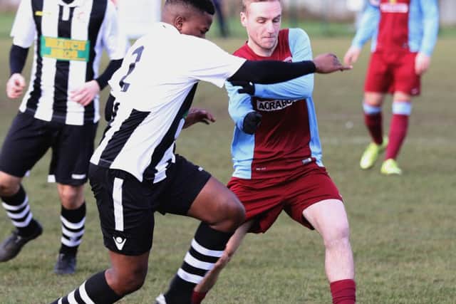 Wilkins Makate of Peterborough Northern Stra battles for possession in the 3-1 United Counties Premier Division defeat by Deeping Rangers. Photo: Tim Gates.