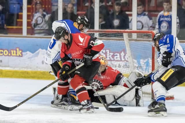 A scramble in front of the Basingstoke net involving Phantoms players James White and James Archer (right). Photo: Tom Scott - AMOimages.