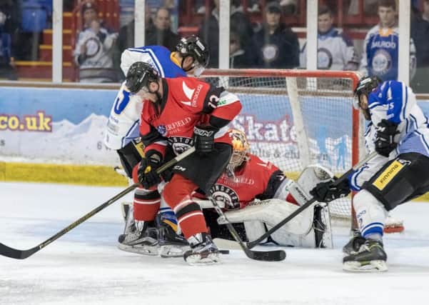 A scramble in front of the Basingstoke net involving Phantoms players James White and James Archer (right). Photo: Tom Scott - AMOimages.