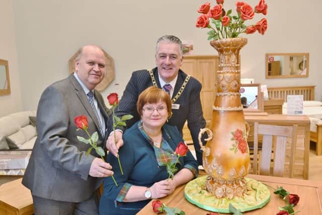 Cake maker Jacqui Kelly with store deputy manager Paul Nicholls and Mayor David Sanders. EMN-170129-090339009