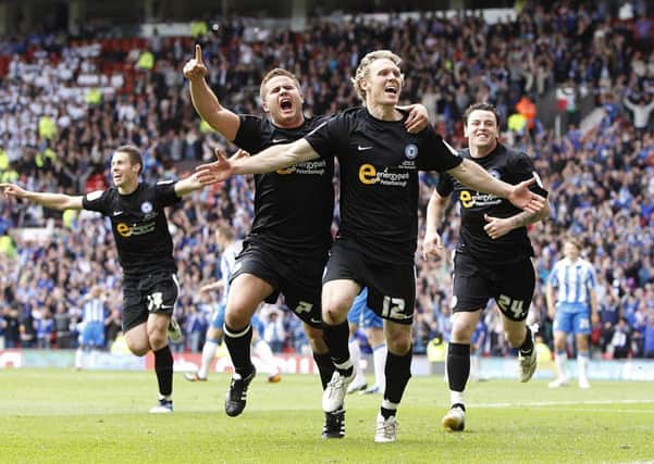 Craig Mackail-Smith celebrates his League One play-off final goal for Posh at Old Trafford in 2011.