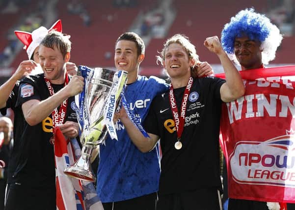 Latest Posh signing Craig Mackail-Smith (centre) and current manager Grant McCann (left) celebrate victory in the 2011 League One play-off final.
