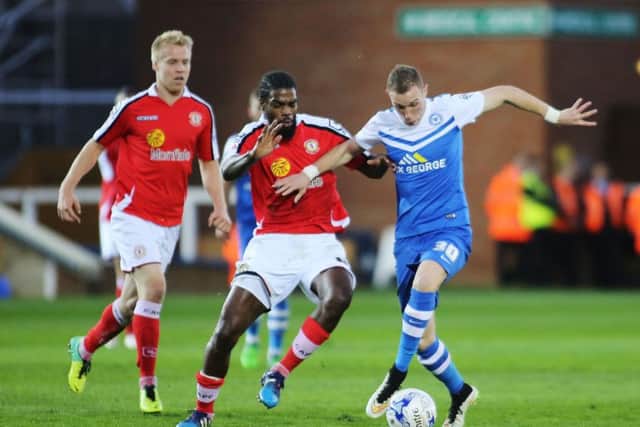 Anthony Grant (left), in his Crewe days, challenges Posh star Marcus Maddison.