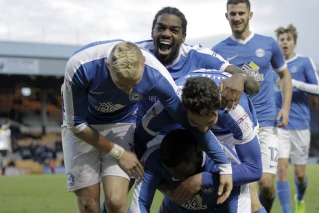 Junior Morias is mobbed by his Posh team-mates after his second goal of the game at Port Vale. Photo: Joe Dent/theposh.com.