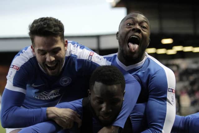 Junior Morias is mobbed by Posh team-mates Brad Inman (left) and Jerome Binnom-Williams (right) after scoring at Port Vale. Photo: Joe Dent/theposh.com.