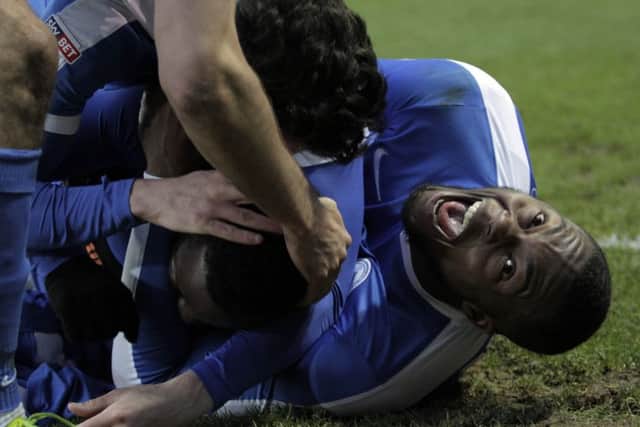 Jerome Binnom-Williams (right) seems pleased with a goal for Posh team-mate Junior Morias. Photo: Joe Dent/theposh.com.