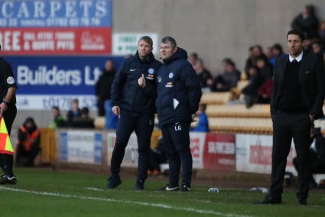 The Posh management team of Grant McCann (left) and Lee Glover look on at Port Vale. Photo: Joe Dent/theposh.com.