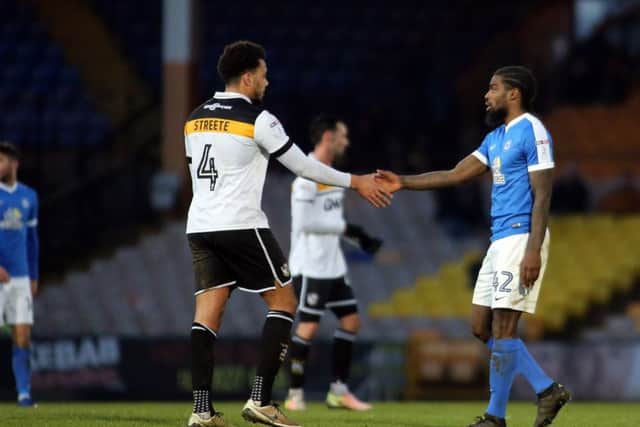 Posh debutant Anthony Grant shakes hands with his former Port Vale team-mate Remi Streete after the match. Photo: Joe Dent/theposh.com.