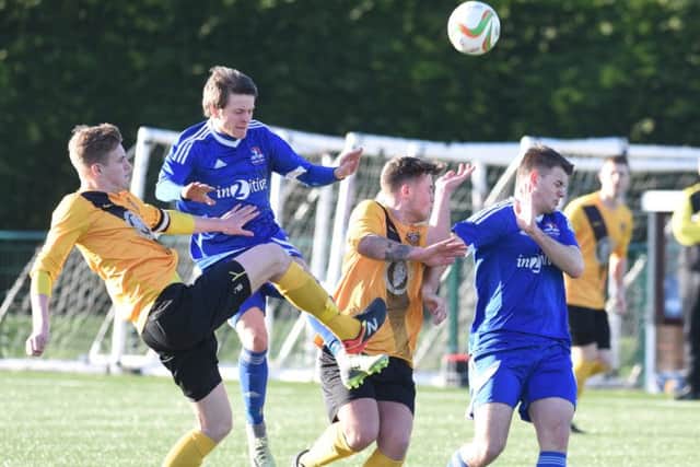 Jack Saunders wins a header for Yaxley in their 4-2 win over Harborough. Photo: David Lowndes.