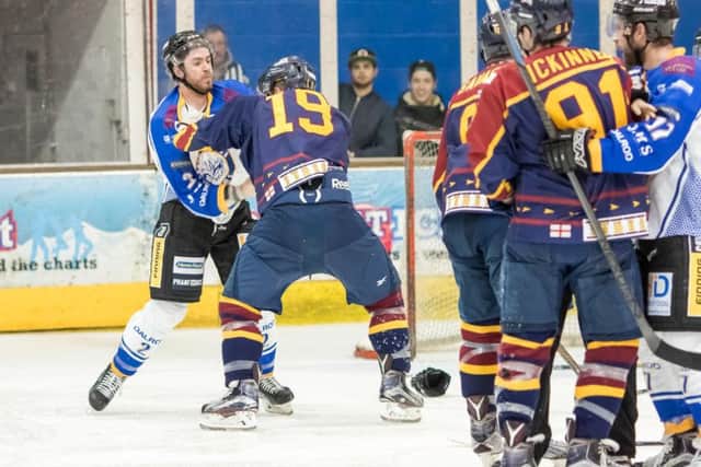 Tom Norton scraps it out with Guildford's Tom Duggan. Picture: Tom Scott