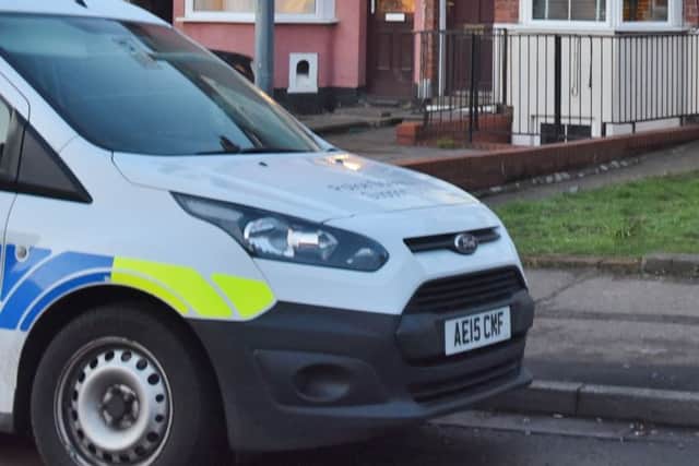 Police at drugs bust at Queen's Drive West. The house with white door is where officers were searching. EMN-170802-082839009