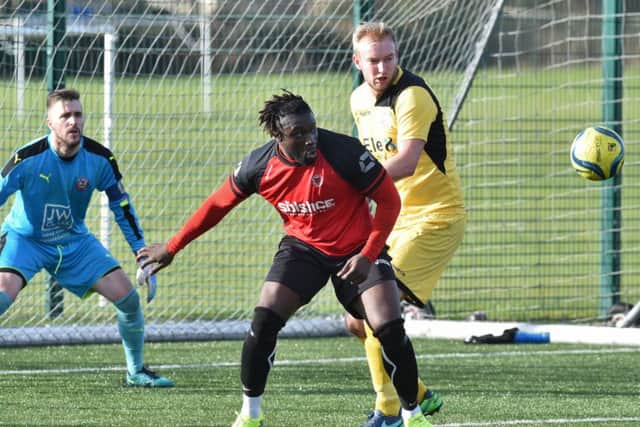 Rob Da Silva (red) in action for Netherton United against Raunds. Photo: David Lowndes.