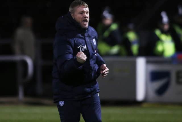 Posh manager Grant McCann celebrates victory at Northampton in front of another decent League One crowd.