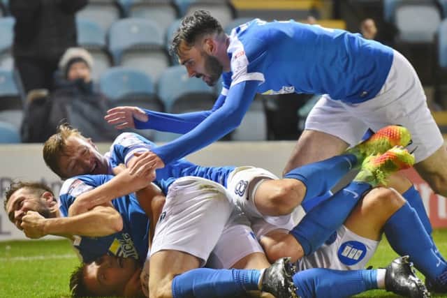 Posh players celebrate a goal against Northampton in front of their biggest home gate of the season.