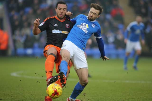 Gwion Edwards of Posh and Sheffield United's Samir Carruthers battale for possession. Photo: Joe Dent/theposh.com.