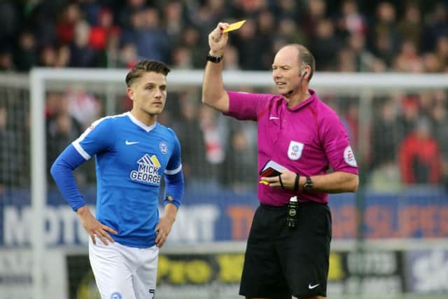 Tom Nichols of Peterborough United is booked by the match referee - Mandatory by-line: Peterborough United Football Club Ltd / PaperPix- 2017 - 16/17 - FOOTBALL - ABAX Stadium - Peterborough, Cambs - Peterborough United v Sheffield United