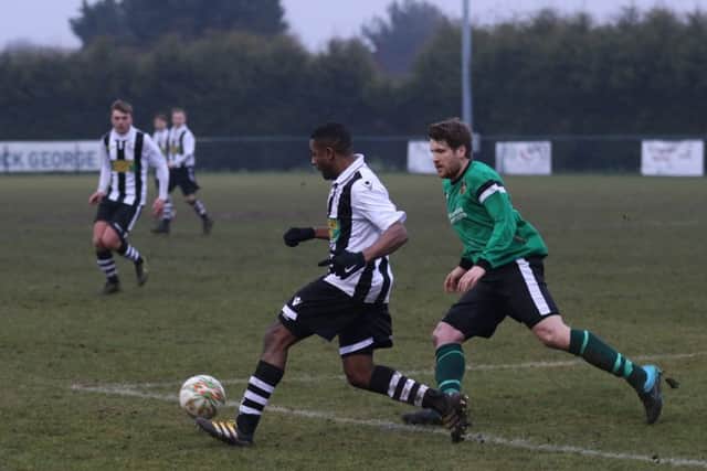 Goal-scorer Christian Gordan (stripes) on the ball for Peterborough Northern Star in their 2-0 win over Sleaford. Photo: Tim Gates.