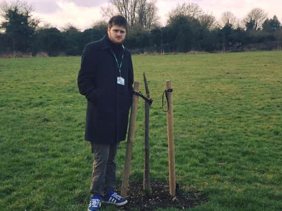 Cllr Andrew Bond with one of the broken trees