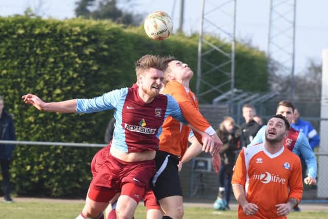 Action from the 0-0 draw between Deeping Rangers (claret) and Yaxley. Photo: David Lowndes.