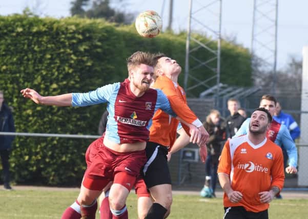 Action from the 0-0 draw between Deeping Rangers (claret) and Yaxley. Photo: David Lowndes.
