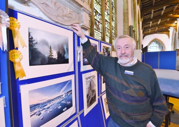 Peterborough Photographic Society annual show at St John's church, Cathedral Square.  Mike Burns with his award winning picture EMN-170220-160314009