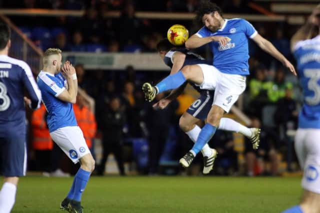 Posh midfielder Michael Bostwick challenges Southend's Simon Cox. Photo: Joe Dent/theposh.com.