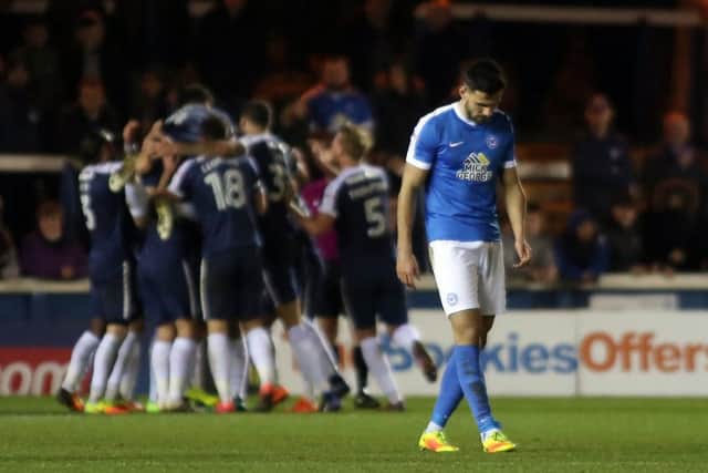 Posh centre-back Ryan Tafazolli cuts a dejected figure as Southend players celebrate their second goal. Photo: Joe Dent/Theposh.com.