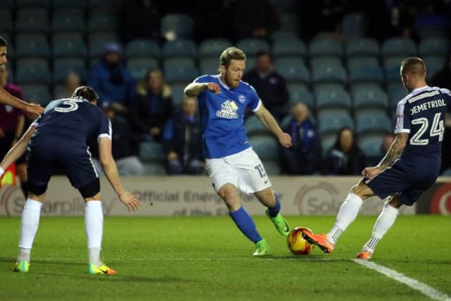 Craig Mackail-Smith of Peterborough United is closed down by the Southend United defence. Picture: Joe Dent