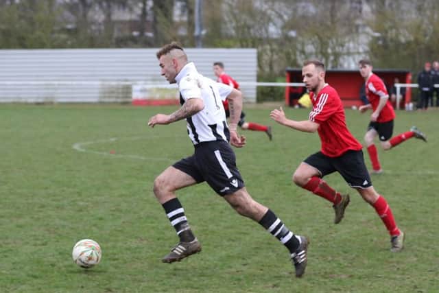 Jake Mason (stripes) in action on his goal-scoring debut for Peterborough Northern Star at Rothwell. Photo: Tim Gates.