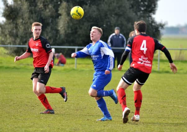 Action from last season's President's Shield semi-final between Moulton Harrox and Netherton United (red).