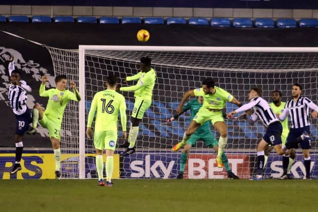Posh midfielder Leo Da Silva Lopes leaps to clear a first-half Millwall corner. Photo: Joe Dent/theposh.com.