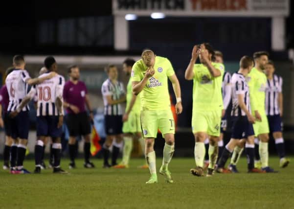 Marcus Maddison's head is bowed as other Posh players applaud the travelling support at Millwall. Photo: Joe Dent/theposh.com.