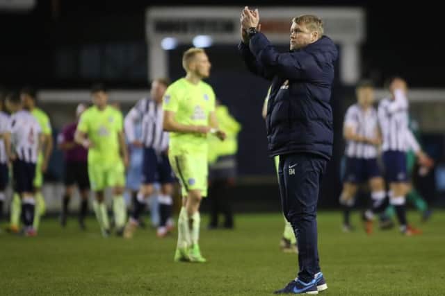 Posh boss Grant McCann acknowledges his club's fans at the end of the Millwall game. Photo: Joe Dent/theposh.com.