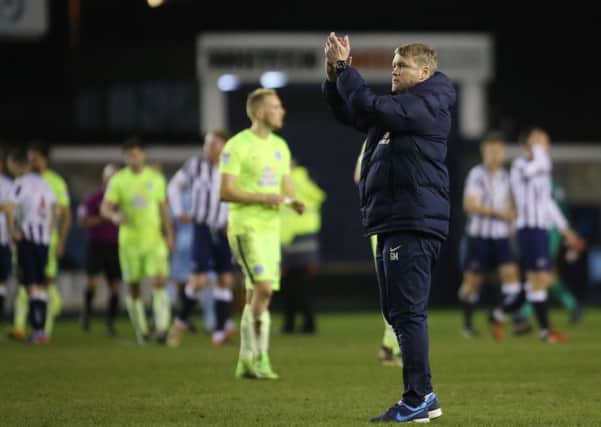 Posh boss Grant McCann acknowledges his club's fans at the end of the Millwall game. Photo: Joe Dent/theposh.com.