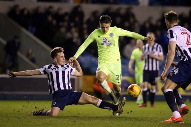 Posh striker Tom Nichols is tackled by Millwall's Ben Thompson. Photo: Joe Dent/theposh.com.
