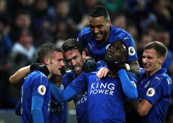 Leicester City players celebrate a goal against Liverpool.