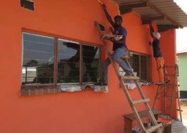 Benson painting the school in Kabaka.