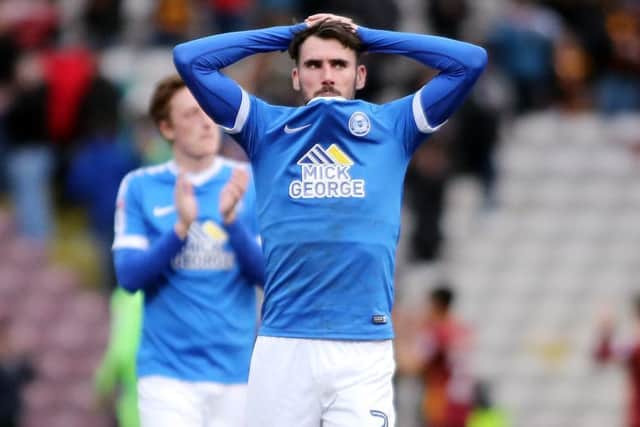Posh right-back Michael Smith is dejected at the final whistle at Bradford City. Photo: Joe Dent/theposh.com.