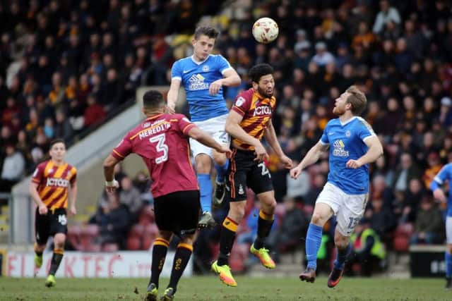 Posh forward Tom Nichols leaps highest at Bradford City. Photo: Joe Dent/theposh.com.