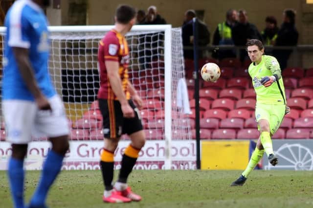 Posh goalkeeper Luke McGee clears the ball at Bradford City. Photo: Joe Dent/theposh.com.